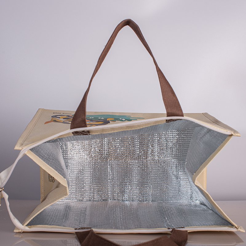 Open top view of custom insulated cooler bag showing wide opening and silver aluminum foil thermal lining inside