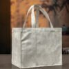 White suede PU tote bag front view Upright white suede PU tote bag placed on a minimalist wooden table