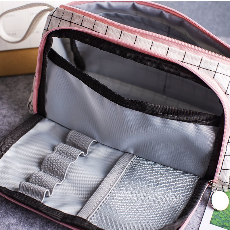 Opened large capacity canvas pencil case showing inner elastic pen loops, mesh pocket, and black binding detail