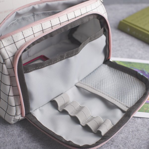 Open pencil case inner organizer Detailed close-up of the opened grid cotton canvas pencil case, showing elastic pen loops, a mesh pocket, and black edge binding.