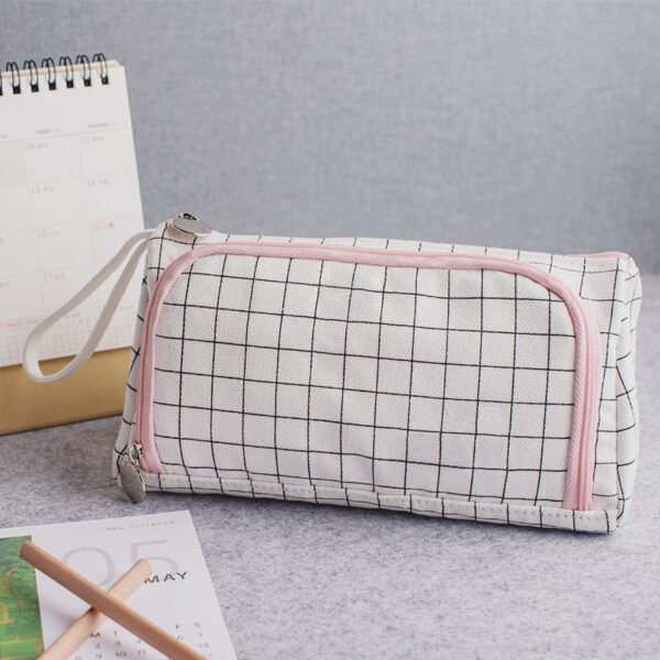 Black grid pencil case with pink zipper Custom black grid cotton canvas pencil case with pink zipper and round metal pull on a desk