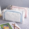 Blue and pink grid pencil cases Two custom cotton canvas grid pencil cases in blue and pink with wrist straps and zippers