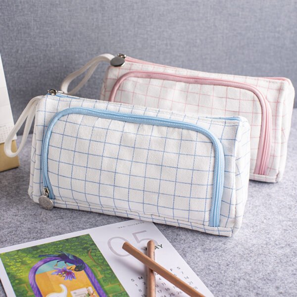 Blue and pink grid pencil cases Two custom cotton canvas grid pencil cases in blue and pink with wrist straps and zippers