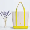 Canvas tote bag lifestyle scene Lifestyle shot of a custom two-tone canvas tote bag with extended handles, perfect for daily shopping and corporate gifts