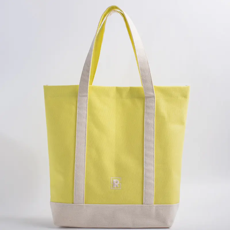 ellow and natural two-tone canvas tote bag with extended handles and embroidered logo